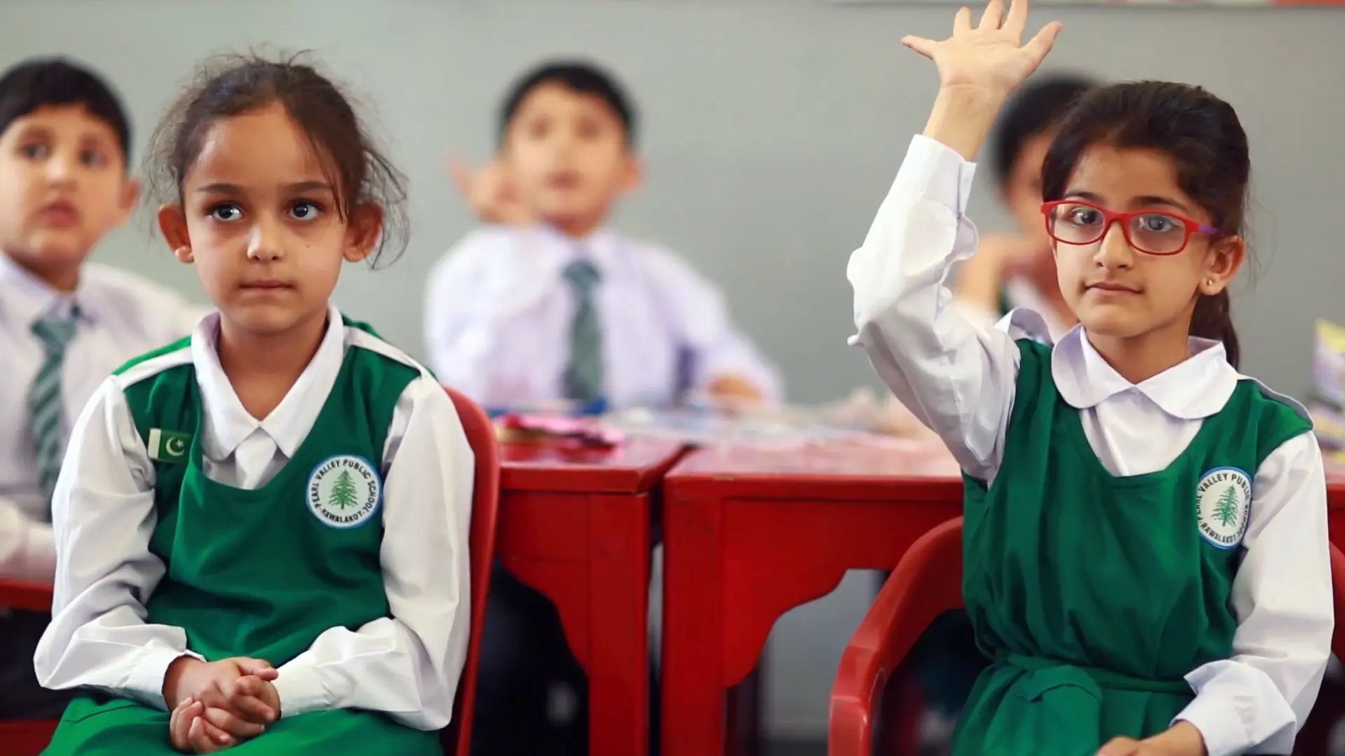 A girl puts her hands up at one of the Kashmir Education Foundation schools A girl puts her hands up at one of the Kashmir Education Foundation schools