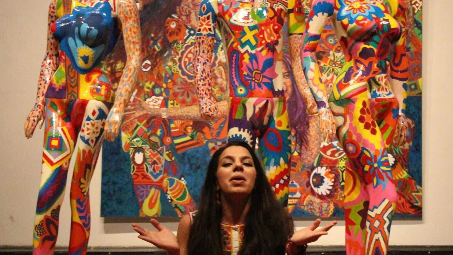 Amina Ansari in front of her art