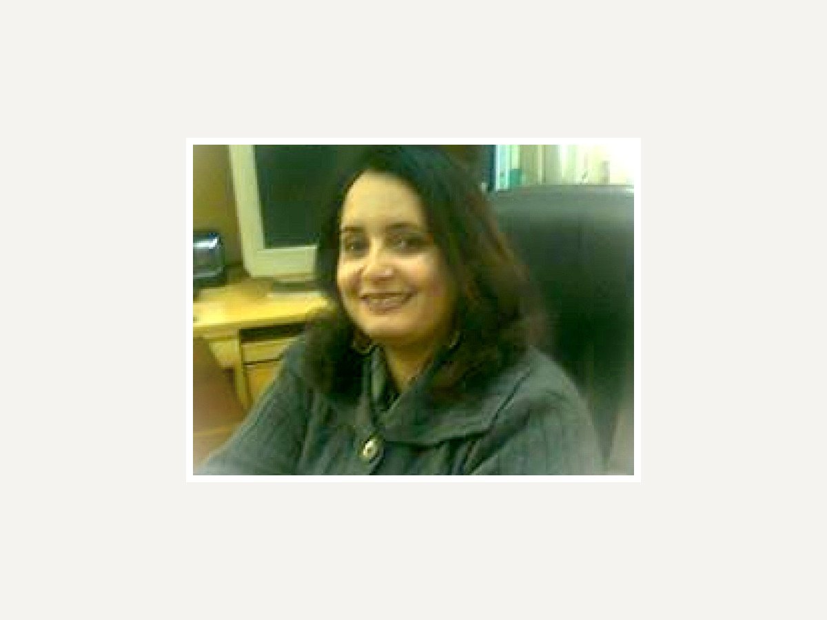 Portrait of Miss Saira Said Ahmed, smiling, framed on a plain background