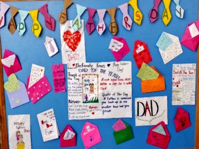 A noticeboard covered with colourful Father's Day cards and envelopes